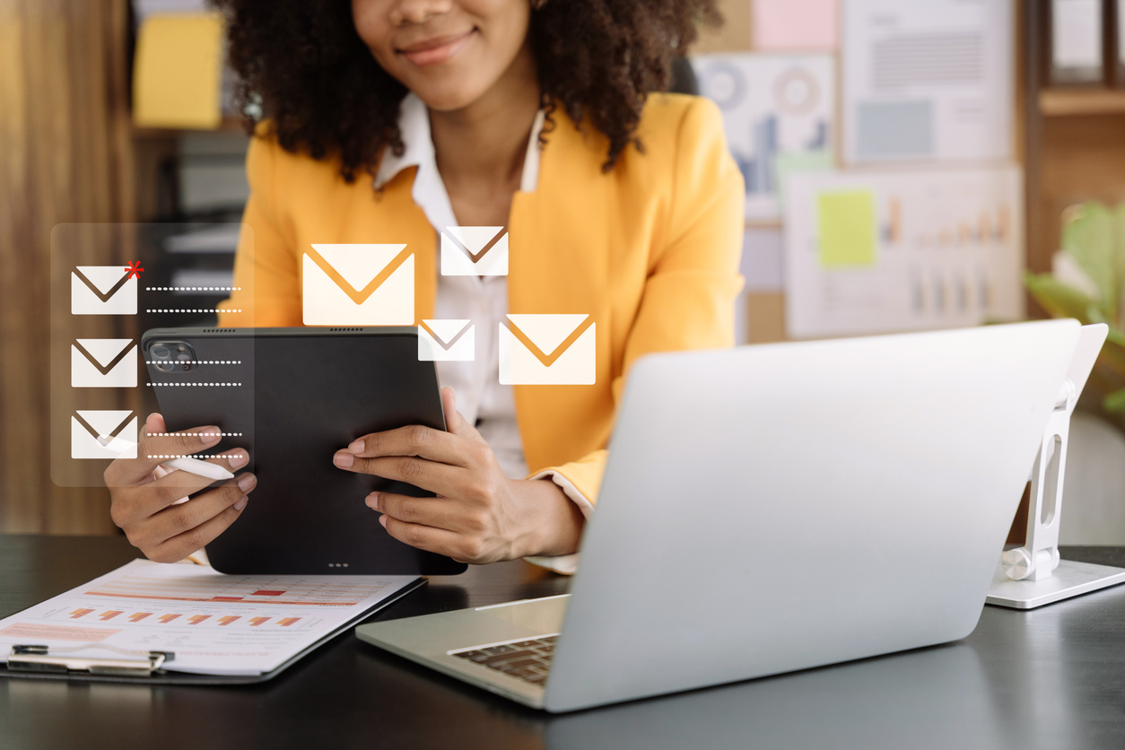 Business email marketing notification concept, Businesswoman use tablet and laptop receive message alert in the mailbox and transfer data at office. email marketing for retail.